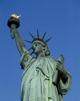 Colorful view of the Statue of Liberty from the torso up, shot from below.